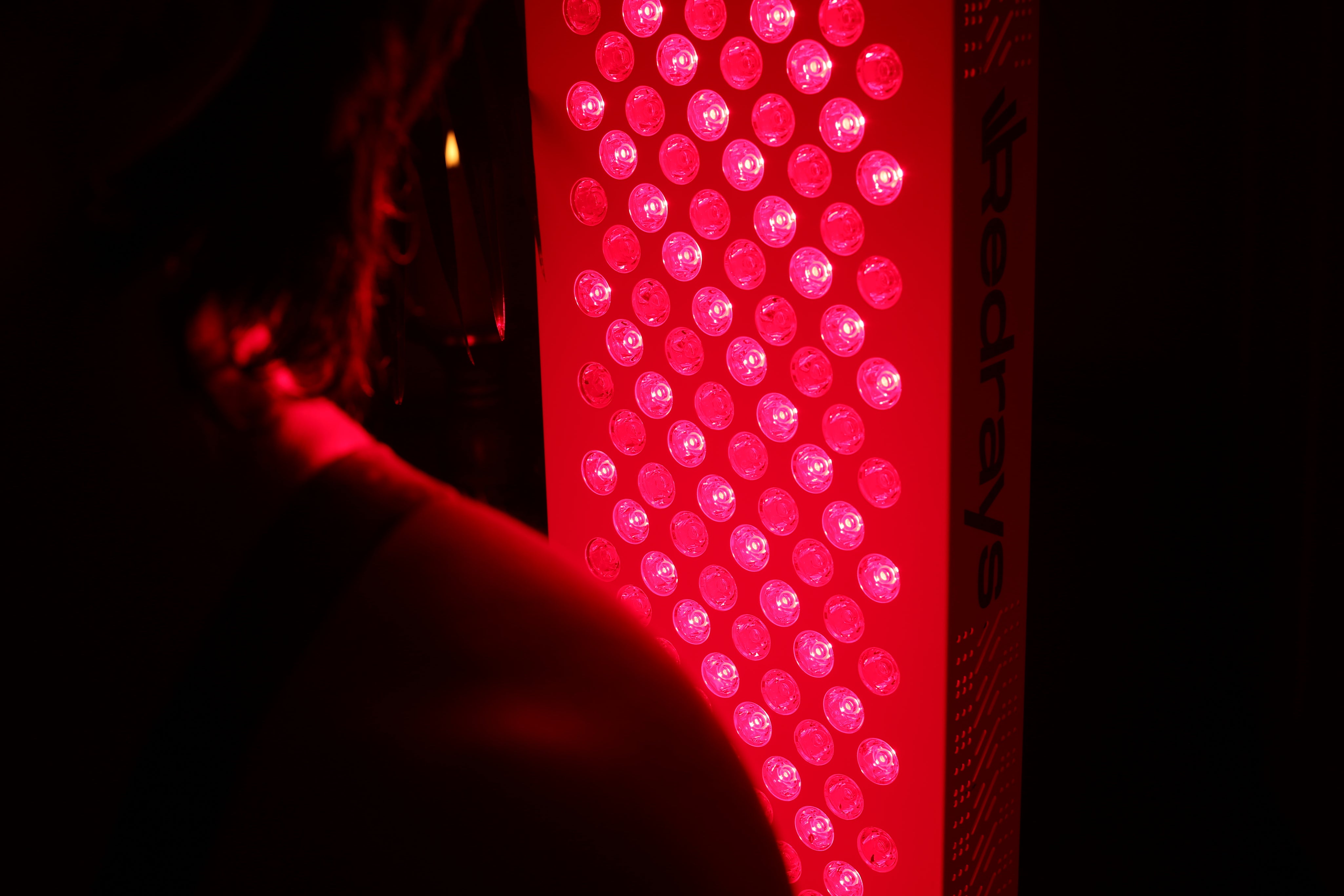 Red LED light panel with &#39;RedRays&#39; branding on a dark background